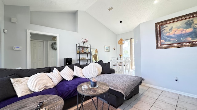 tiled living room with a textured ceiling and high vaulted ceiling