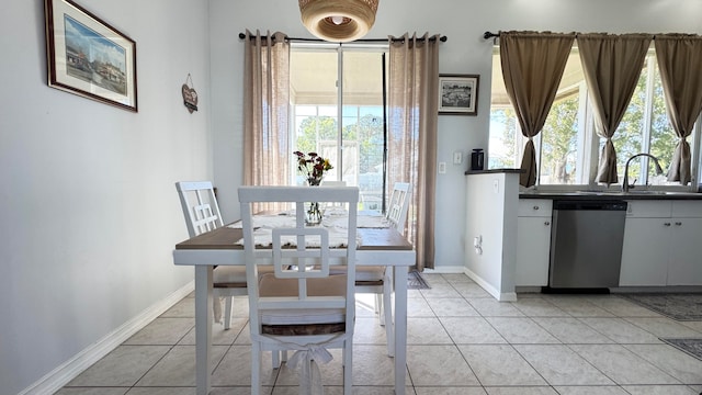 tiled dining space with plenty of natural light and sink