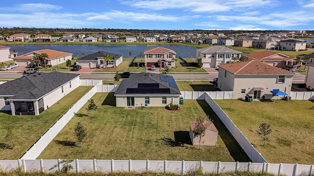 birds eye view of property featuring a water view and a residential view