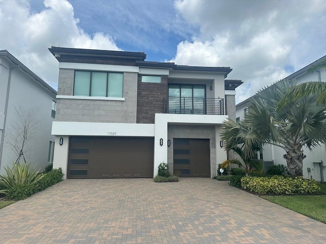 modern home with a balcony and a garage