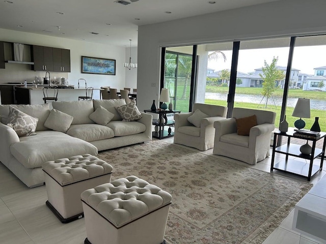 living room with sink and an inviting chandelier