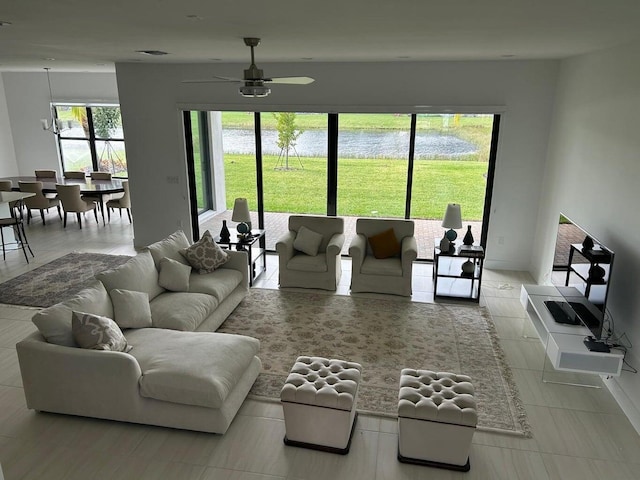 tiled living room featuring ceiling fan and a wealth of natural light