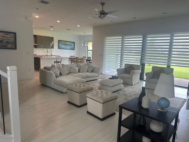 living room with ceiling fan, light tile patterned floors, and plenty of natural light