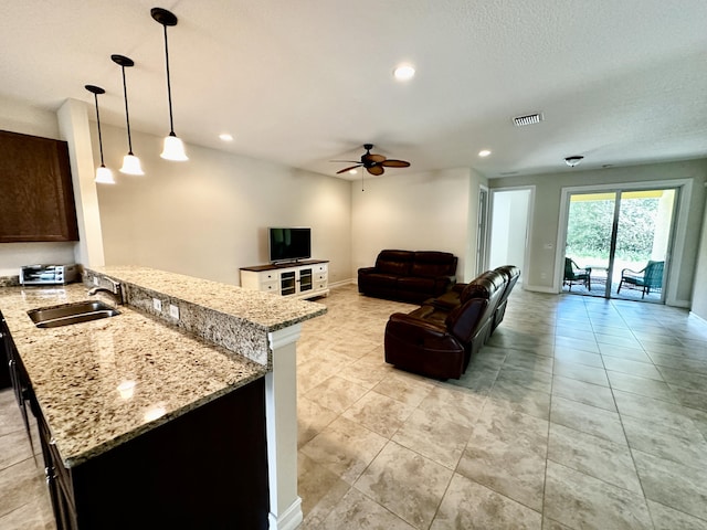 living area with recessed lighting, visible vents, and baseboards