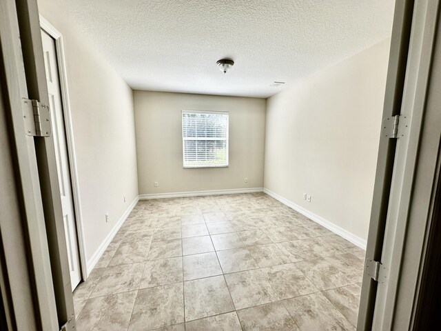 unfurnished bedroom with a textured ceiling