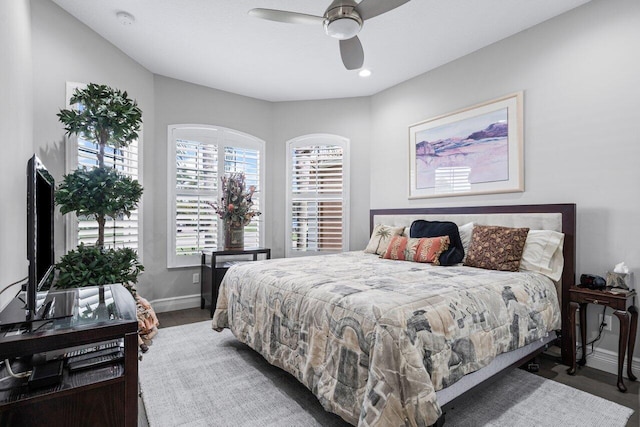 bedroom with ceiling fan and dark hardwood / wood-style flooring