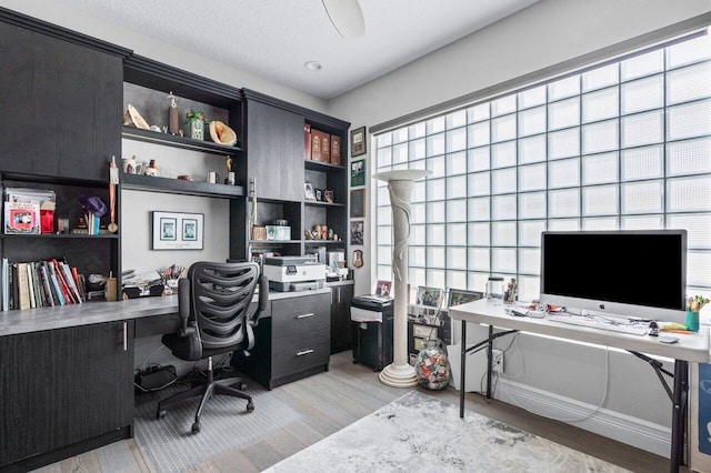 office space with light hardwood / wood-style floors and a textured ceiling