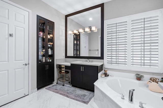 bathroom featuring tiled bath and vanity