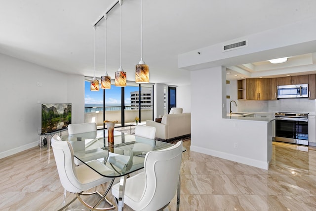 dining area featuring sink and track lighting