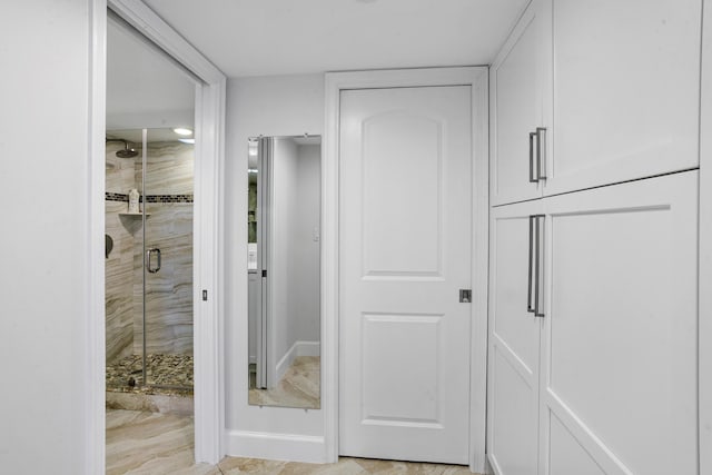 bathroom with a shower with door