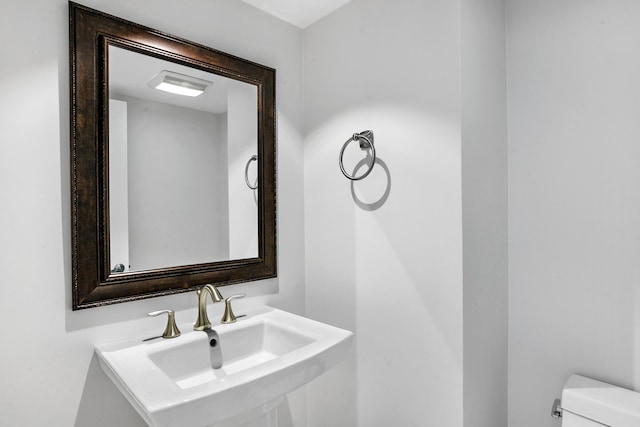 bathroom featuring toilet and sink