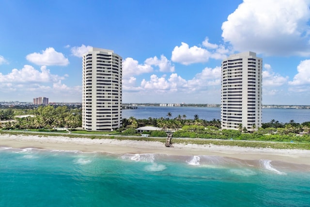 exterior space featuring a water view and a beach view