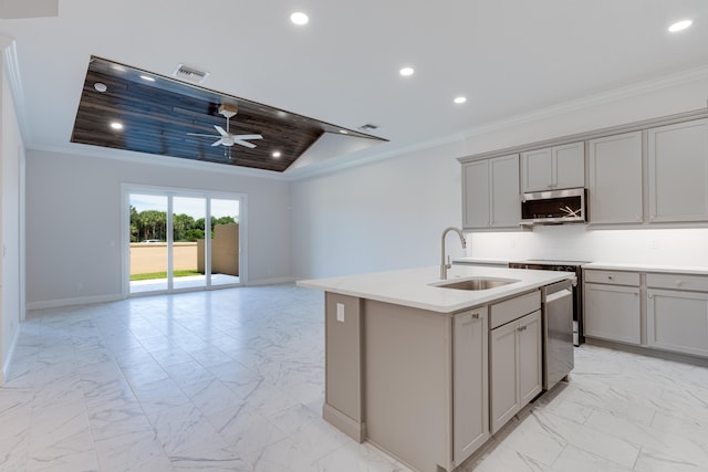 kitchen featuring stainless steel appliances, sink, an island with sink, and gray cabinetry