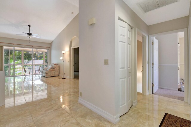 empty room with light colored carpet and vaulted ceiling