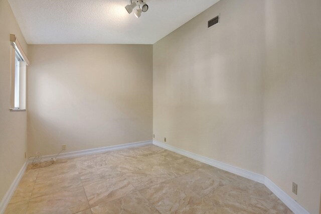 bedroom with light carpet and a textured ceiling