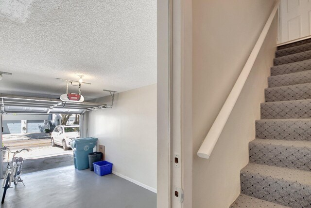 bedroom with ceiling fan, a closet, light colored carpet, and a textured ceiling