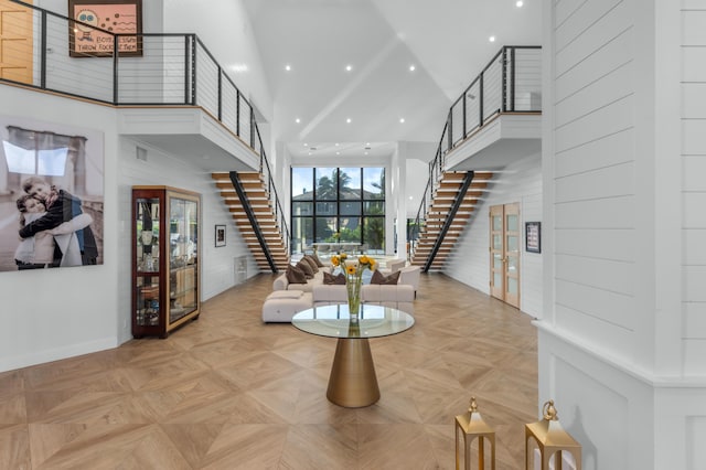 interior space featuring a high ceiling and light parquet flooring