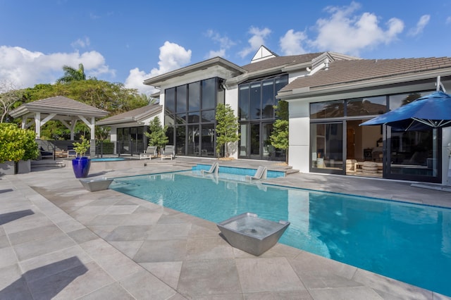 view of swimming pool featuring a patio area and a gazebo