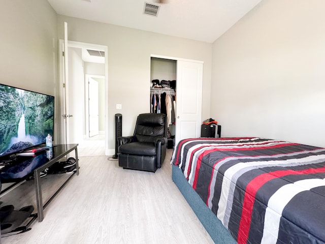 bedroom featuring wood-type flooring and a closet