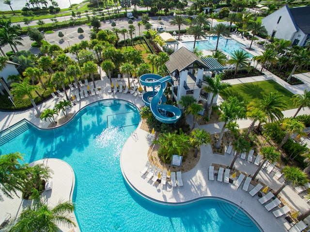 view of pool with a water slide and a patio area