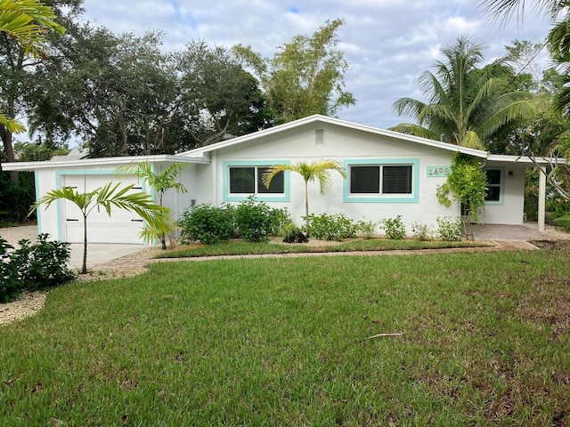 ranch-style home with a garage and a front yard