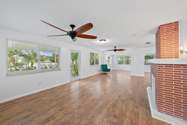 interior space with hardwood / wood-style flooring, plenty of natural light, and a textured ceiling