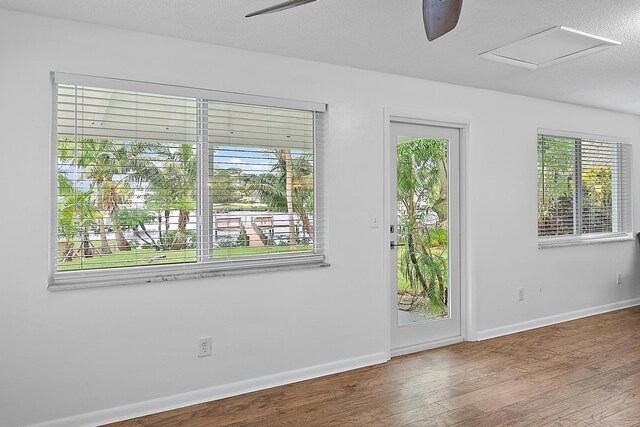 unfurnished room featuring hardwood / wood-style floors, a textured ceiling, and ceiling fan