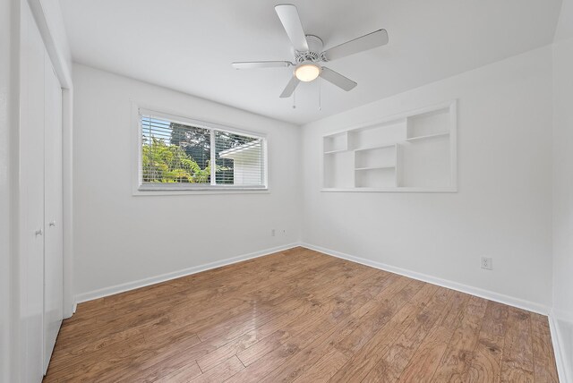 unfurnished room with hardwood / wood-style flooring and ceiling fan