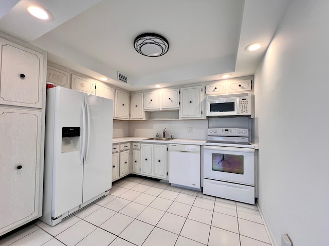 kitchen featuring light tile patterned floors, white appliances, white cabinets, and sink