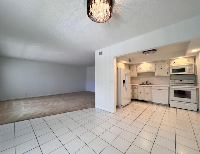 kitchen with light colored carpet, a textured ceiling, sink, white cabinetry, and white appliances