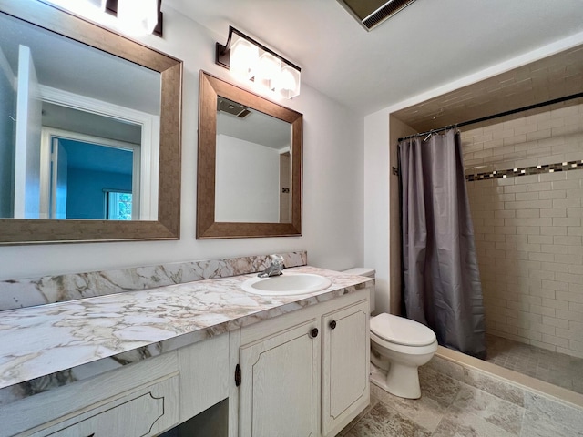 bathroom featuring walk in shower, vanity, and toilet