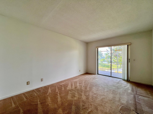 unfurnished room featuring carpet flooring, baseboards, and a textured ceiling