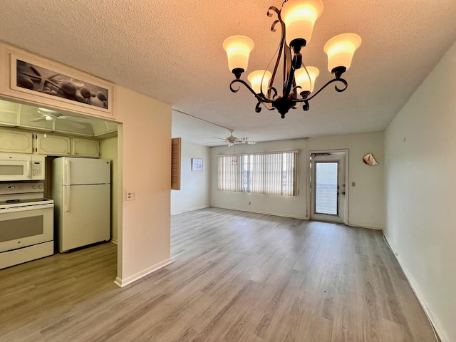 interior space with a textured ceiling, green cabinetry, light hardwood / wood-style flooring, white appliances, and ceiling fan with notable chandelier