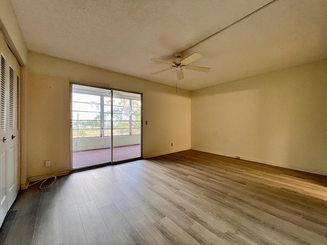 unfurnished room featuring light wood-type flooring, a textured ceiling, and ceiling fan