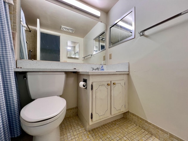 bathroom with tile patterned flooring, vanity, and toilet