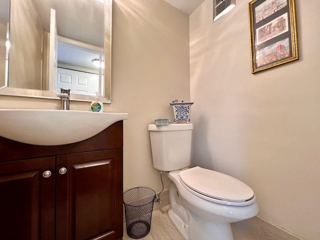 bathroom featuring tile patterned flooring, vanity, and toilet