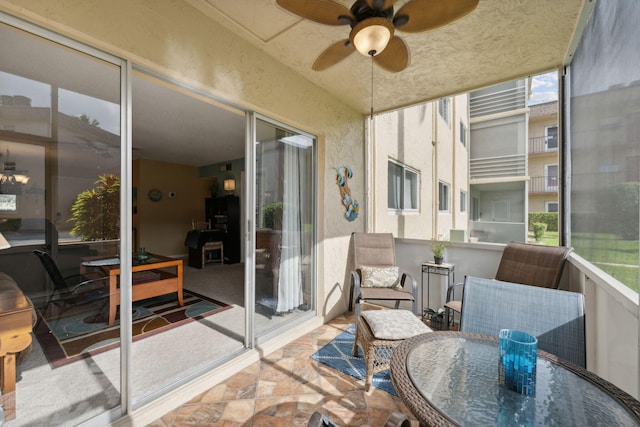 sunroom / solarium featuring ceiling fan