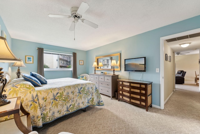 carpeted bedroom with a textured ceiling and ceiling fan