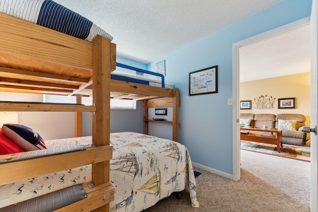 carpeted bedroom featuring a textured ceiling