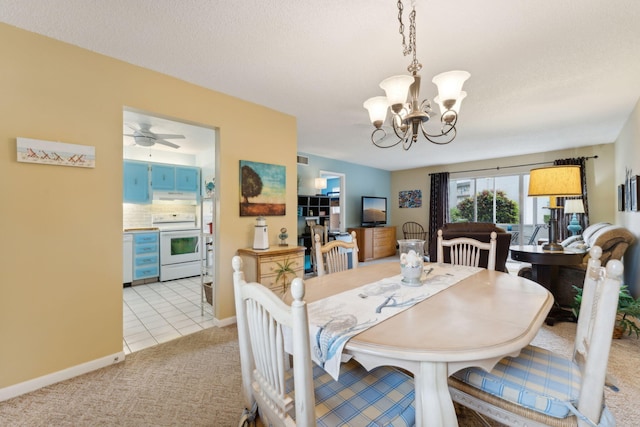 dining area featuring ceiling fan with notable chandelier and light carpet