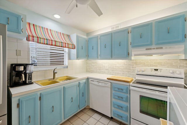 kitchen with blue cabinetry, white appliances, and sink