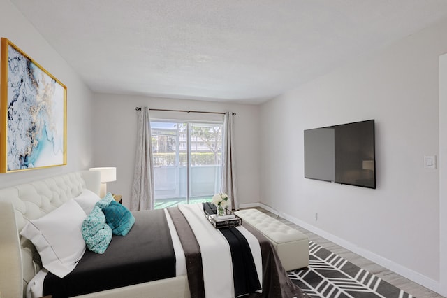 bedroom with wood-type flooring and a textured ceiling