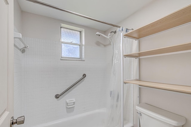 bathroom featuring shower / tub combo and toilet