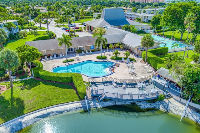 view of swimming pool with a water view, a yard, and a patio