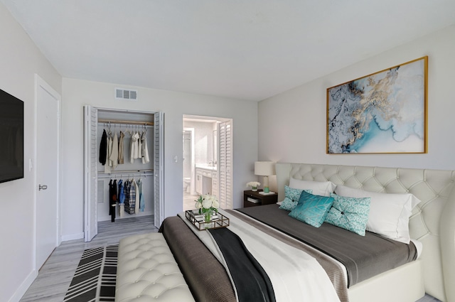 bedroom featuring light wood-type flooring and a closet