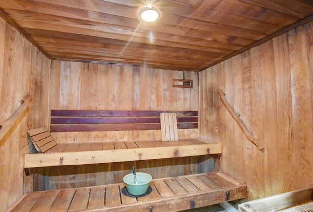 view of sauna with wooden walls and wood ceiling