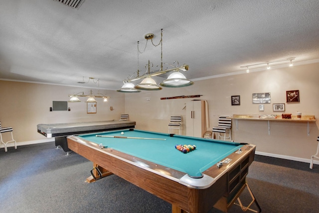 recreation room with dark carpet, crown molding, and a textured ceiling