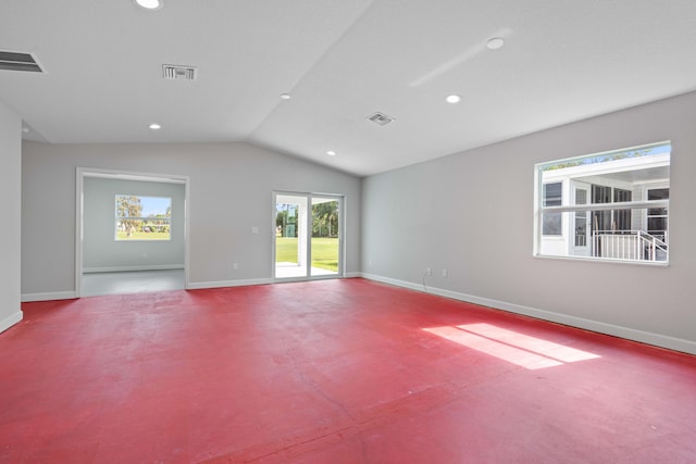 unfurnished living room with carpet floors and vaulted ceiling