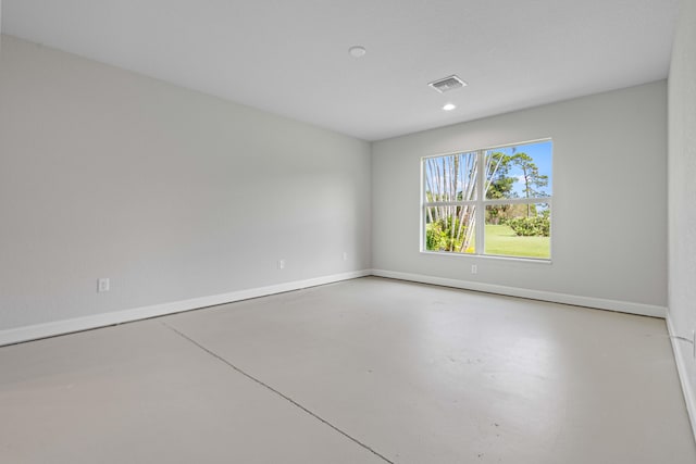 unfurnished room with concrete flooring