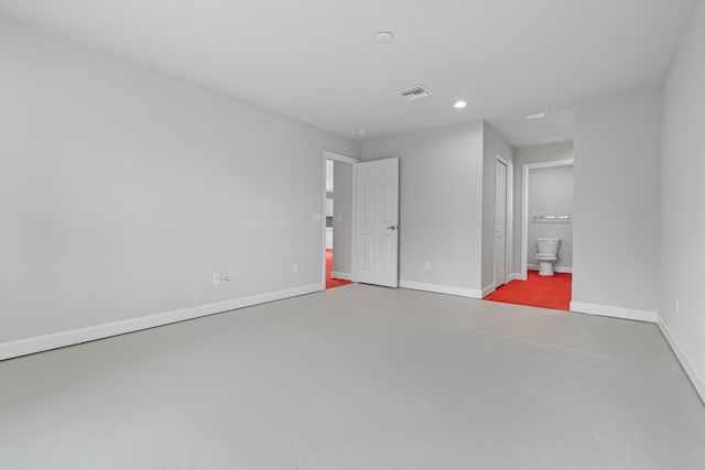 unfurnished room with concrete flooring